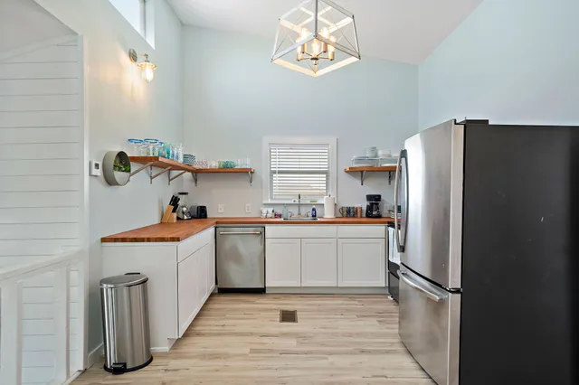 a kitchen with a refrigerator and a sink