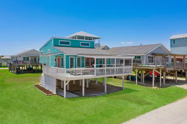 a front view of a house with a yard and balcony