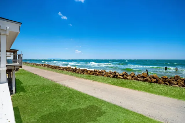 a view of a lake with houses in back