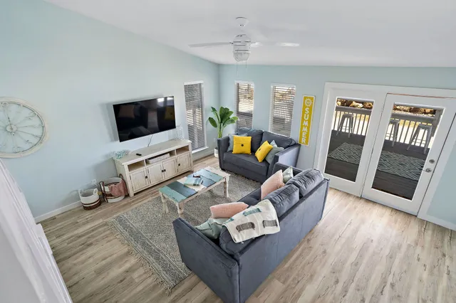 a living room with furniture and a flat screen tv