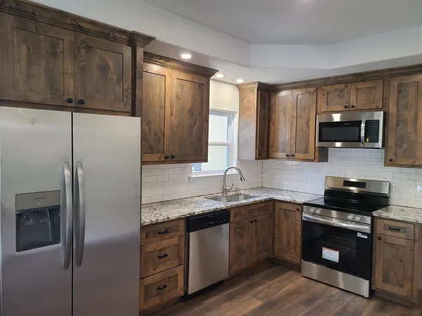 a kitchen with a sink stove and refrigerator