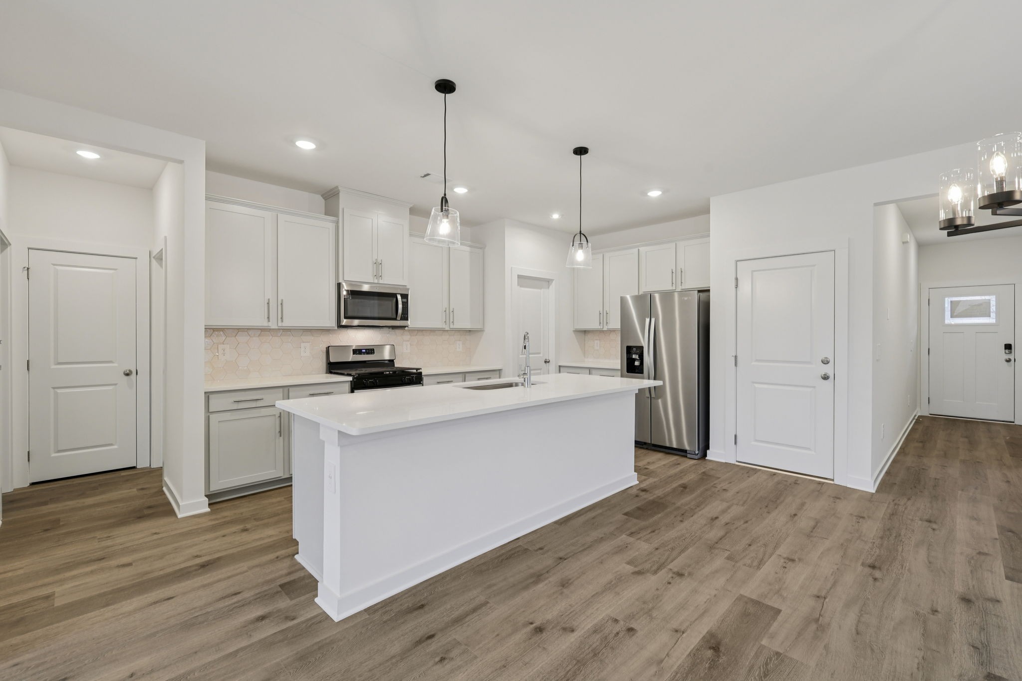 1524 Bear Branch Trace Columbia, TN 38401 - Photo 11 of 55 a kitchen with kitchen island a sink stainless steel appliances and wooden floor