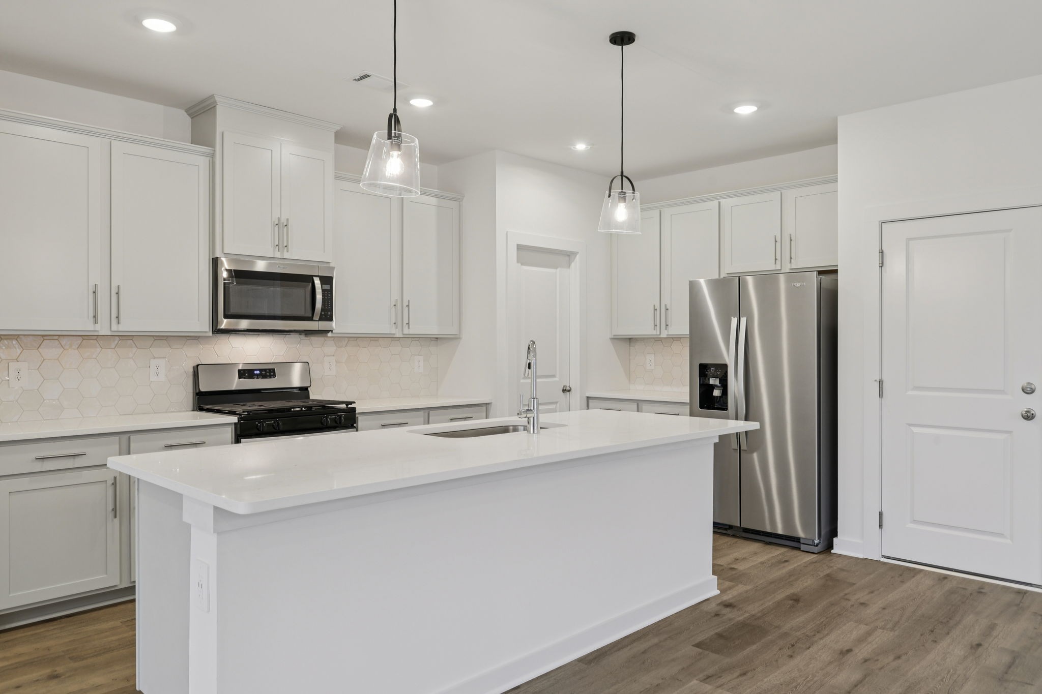 1524 Bear Branch Trace Columbia, TN 38401 - Photo 12 of 55 a kitchen with kitchen island a sink stainless steel appliances and cabinets