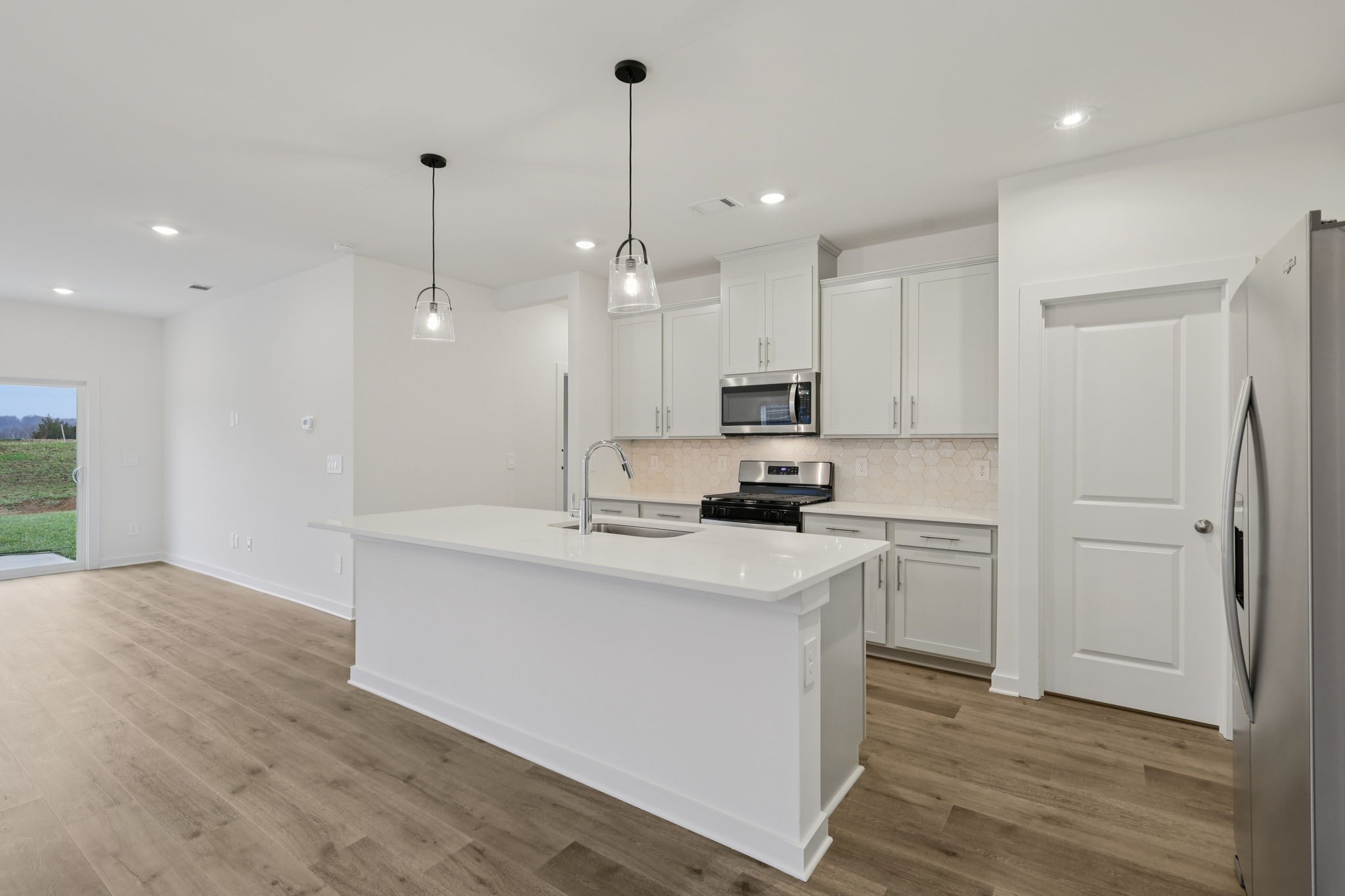 1524 Bear Branch Trace Columbia, TN 38401 - Photo 9 of 55 a kitchen with kitchen island a sink stainless steel appliances and cabinets