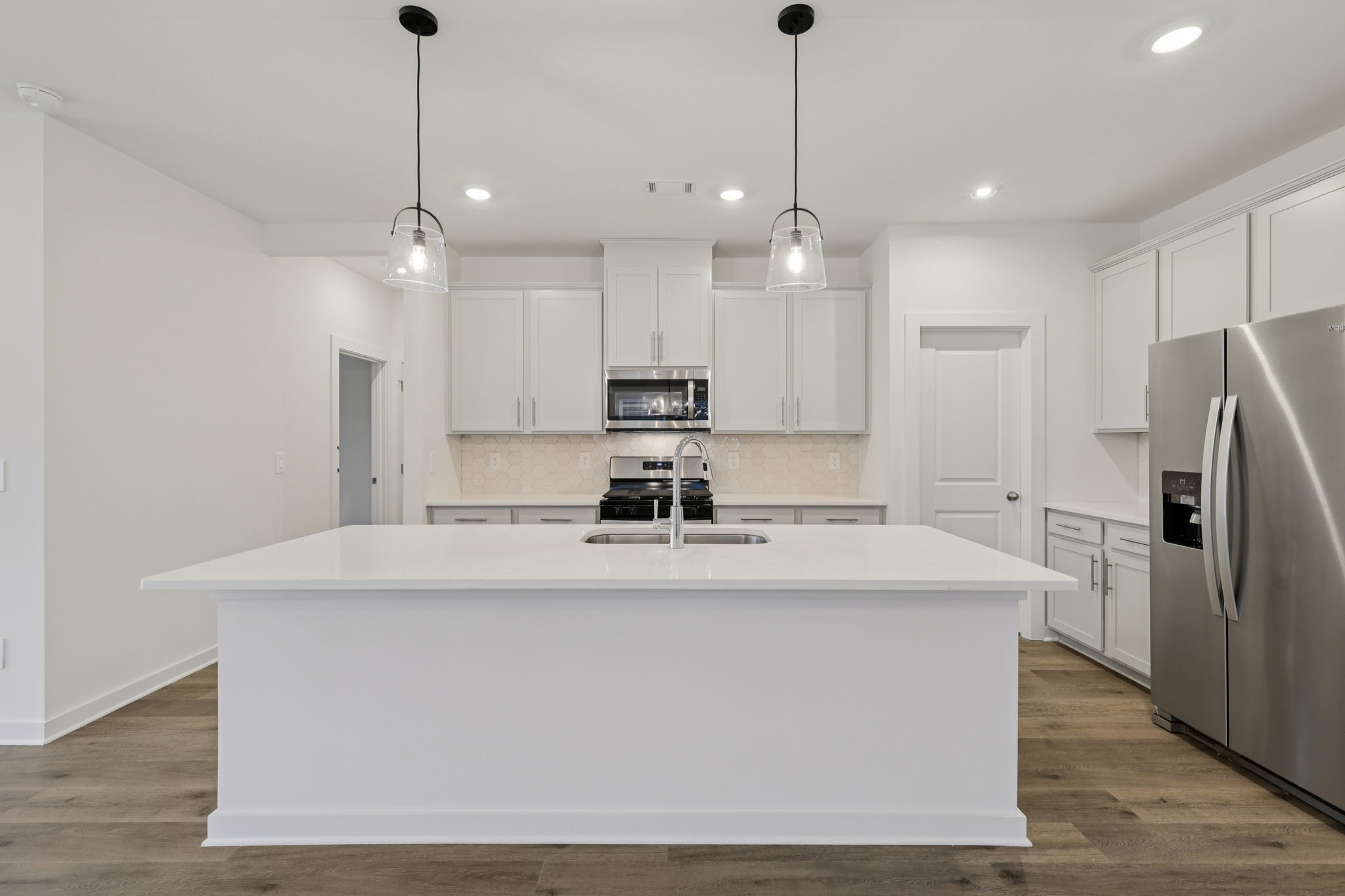 1524 Bear Branch Trace Columbia, TN 38401 - Photo 10 of 55 a view of a kitchen with kitchen island a stove a refrigerator a sink and a counter top space