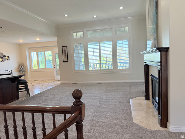 1562 Fairway Ridge Road Draper, UT 84020 - Photo 6 of 60 Open-concept living space with light gray carpeting, a dark wood-finish fireplace surround with a tiled hearth, and large windows featuring plantation shutters