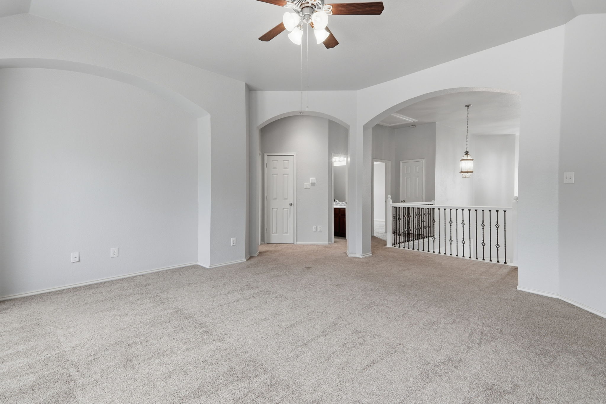 500 Red Hawk Drive Leander, TX 78641 - Photo 22 of 35 Carpeted spare room featuring ceiling fan and arched walkways