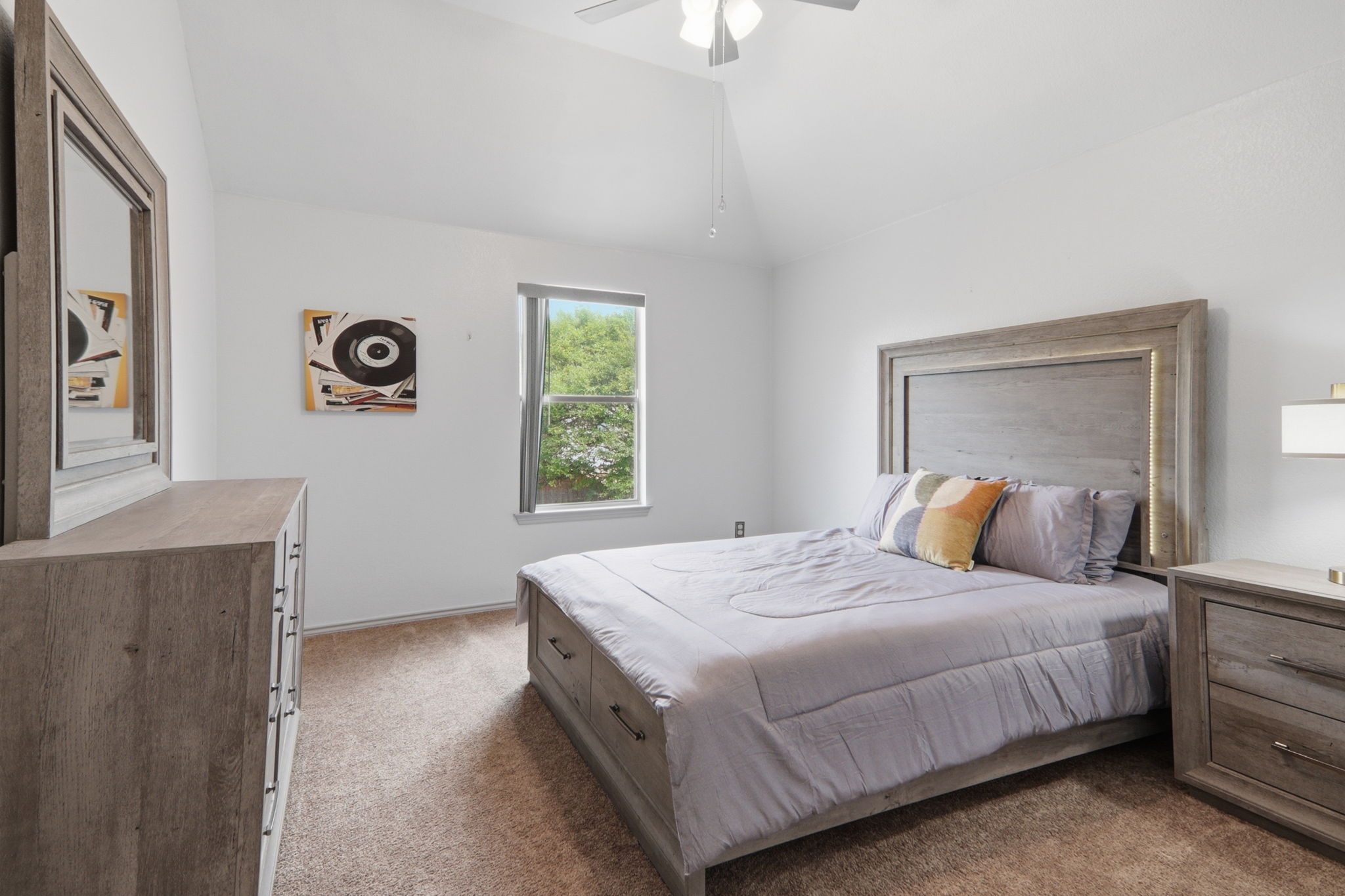 500 Red Hawk Drive Leander, TX 78641 - Photo 24 of 35 Bedroom with dark carpet, vaulted ceiling, and ceiling fan