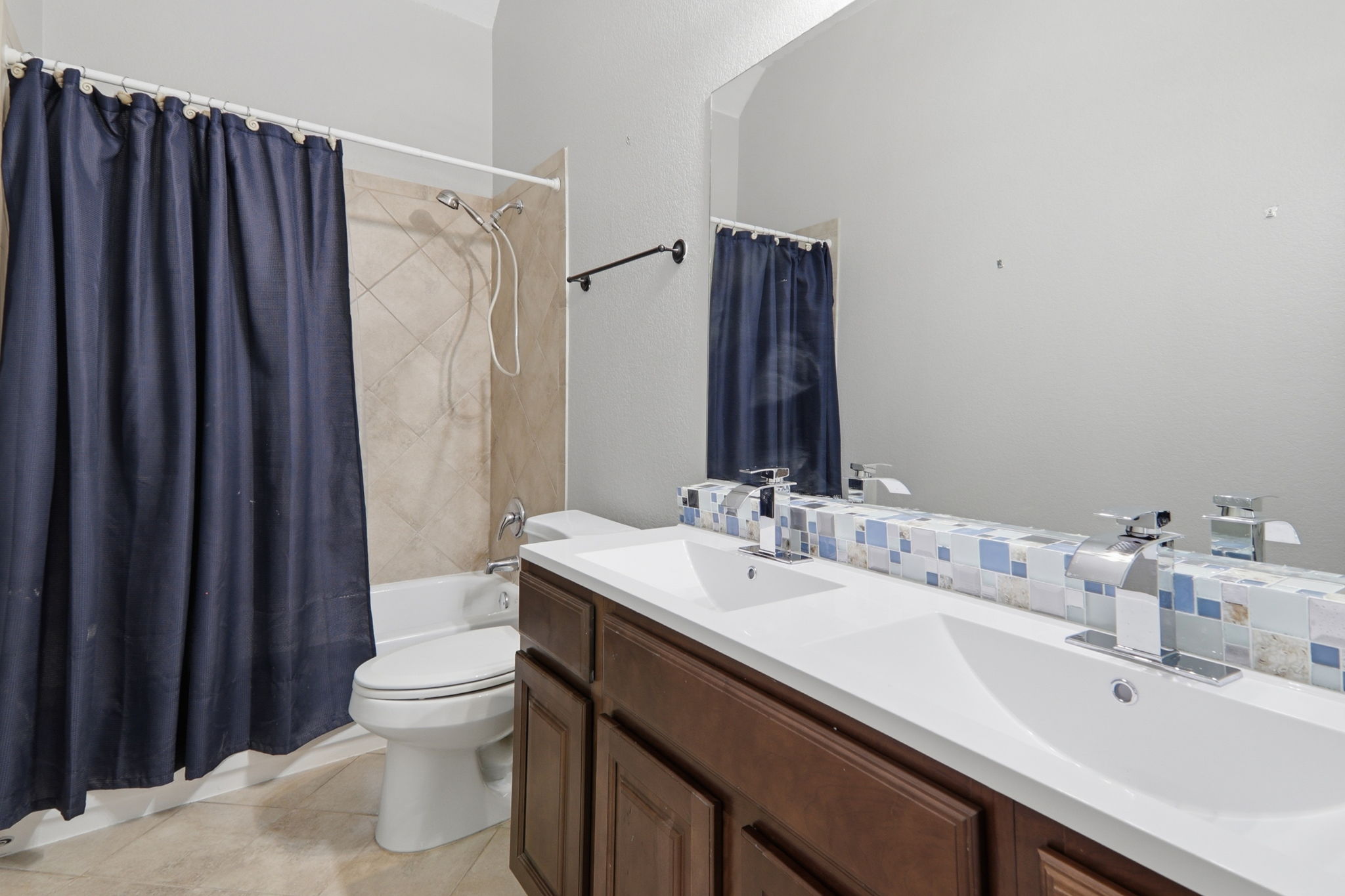500 Red Hawk Drive Leander, TX 78641 - Photo 26 of 35 Full bath with double vanity, shower / tub combo, and light tile patterned floors