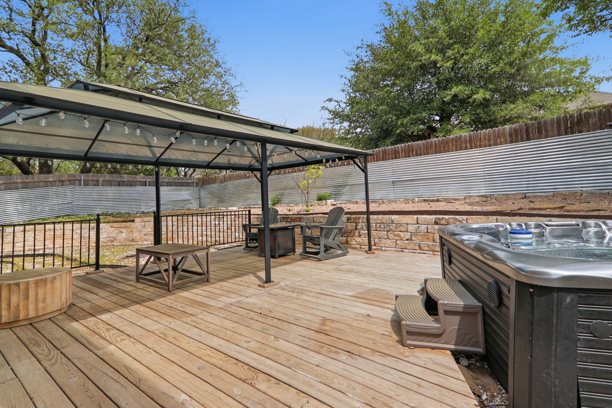500 Red Hawk Drive Leander, TX 78641 - Photo 34 of 35 Wooden deck with a gazebo, a fenced backyard, and a hot tub