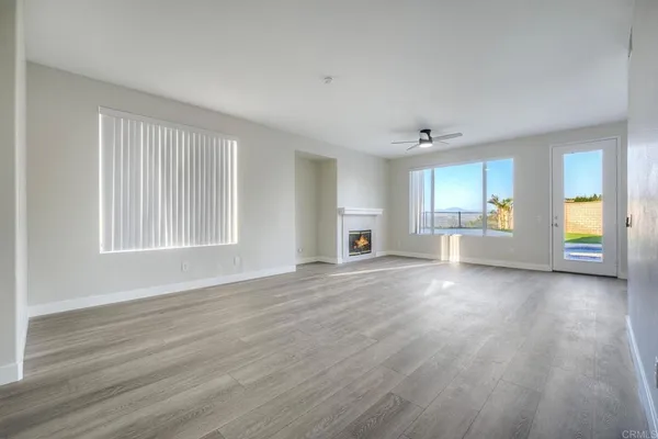 a view of an empty room and fire place