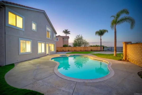 a aerial view of a house with a yard and sitting area