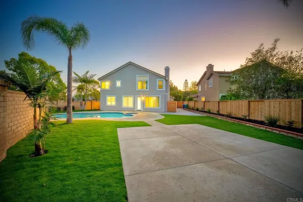 a kitchen with refrigerator cabinets and wooden floor