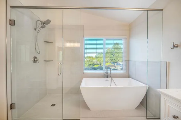 a spacious bathroom with a double vanity sink a mirror a toilet and vanity