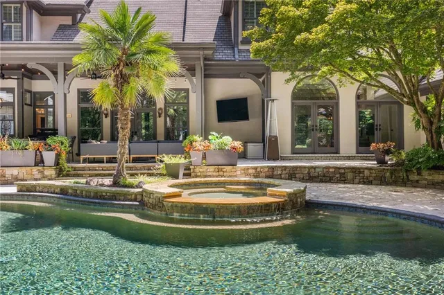 a view of a house with a backyard and a fountain