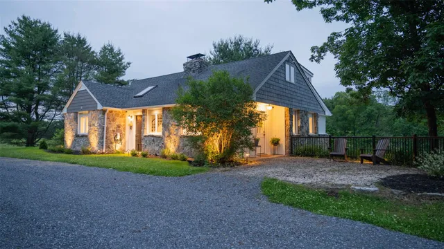a view of a house with a yard and pathway