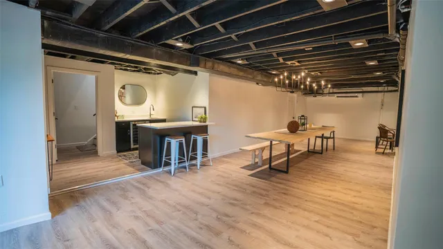 a view of a room with wooden floor table and chairs