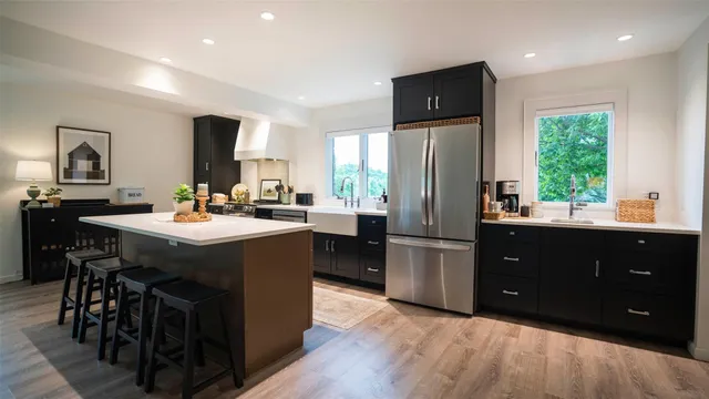 a kitchen with a sink appliances and cabinets