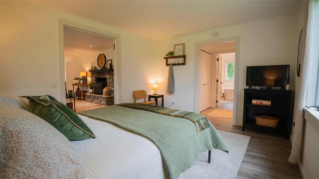 a bedroom with a bed and a television