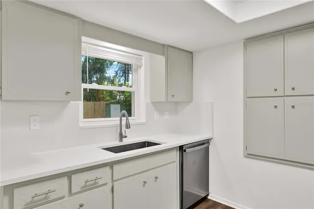 a kitchen with a sink and cabinets