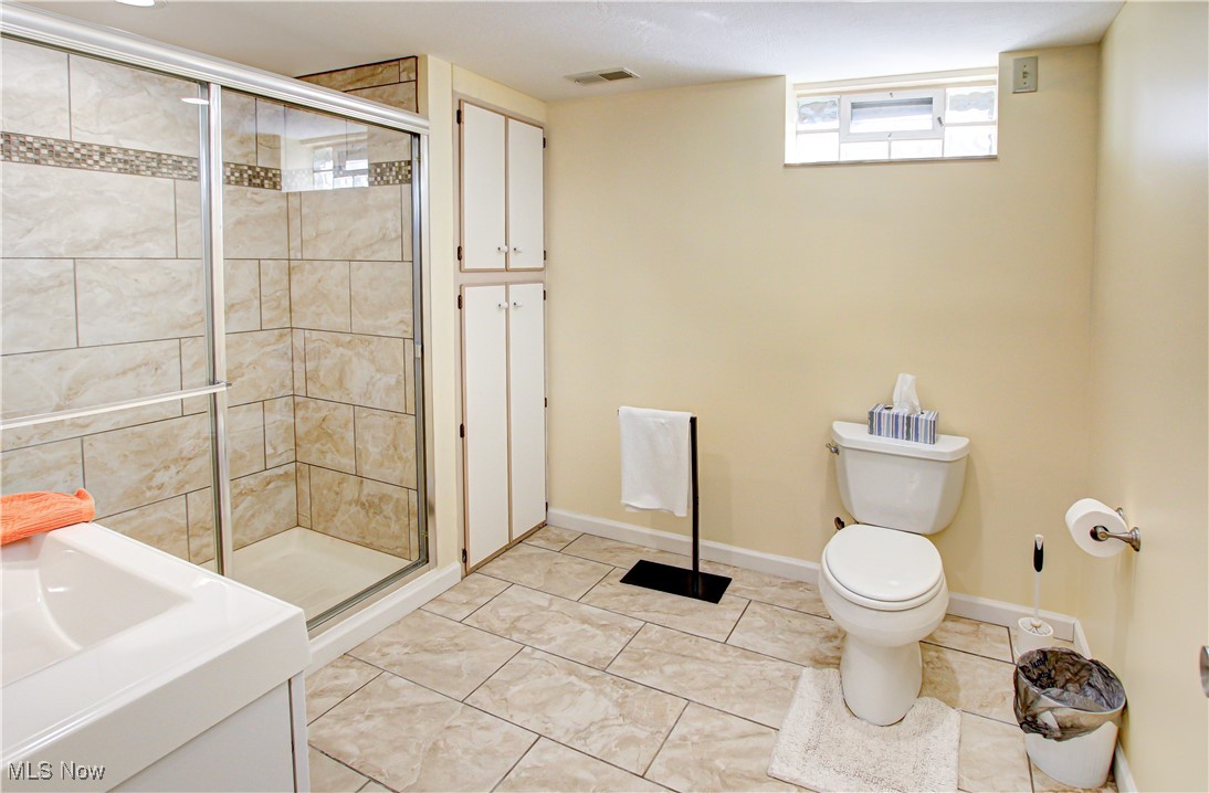 4234 Grafton Road Brunswick, OH 44212 - Photo 28 of 40 Bathroom with a shower with shower door, toilet, and tile patterned flooring