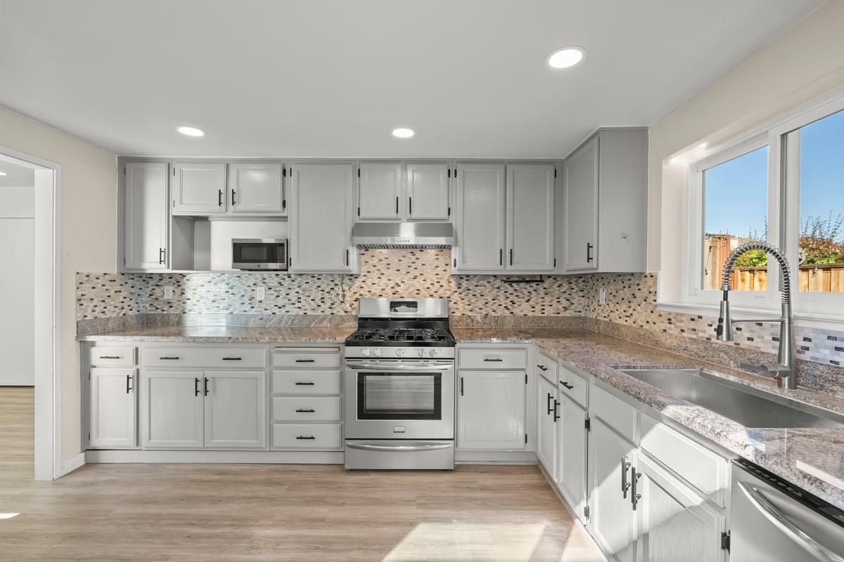 52 Winding Way Watsonville, CA 95076 - Photo 13 of 29 a kitchen with stainless steel appliances granite countertop a stove a sink and a refrigerator