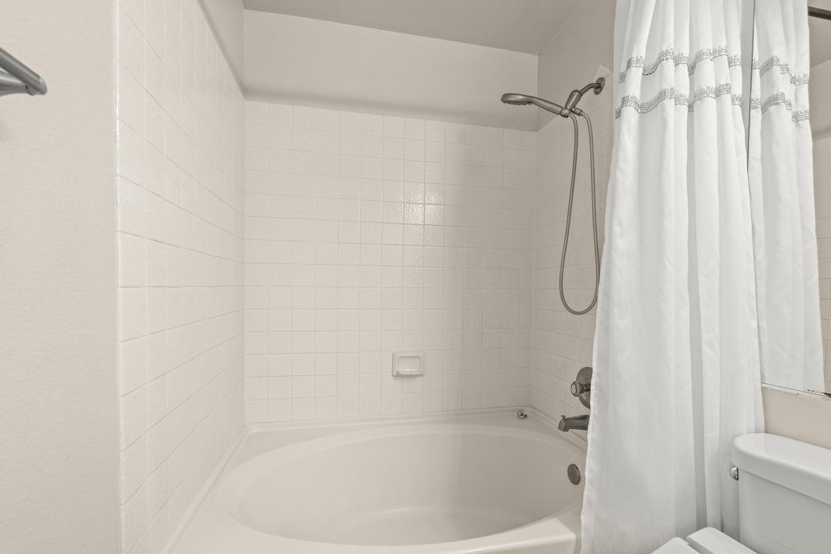 52 Winding Way Watsonville, CA 95076 - Photo 20 of 29 a white bath tub with a shower curtain