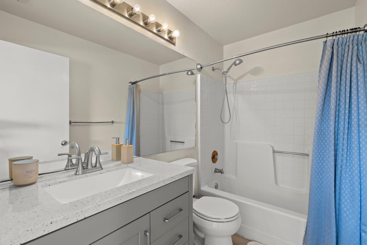 52 Winding Way Watsonville, CA 95076 - Photo 22 of 29 a bathroom with a granite countertop sink a toilet and shower