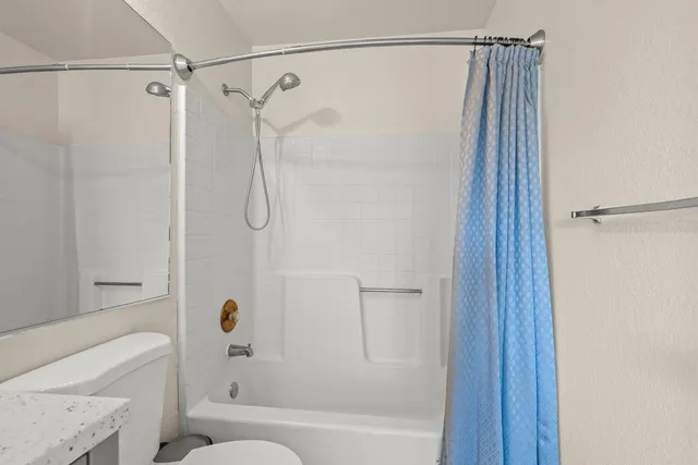 a bathroom with a shower and a bath tub