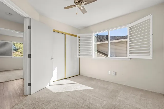 an empty room with windows and closet