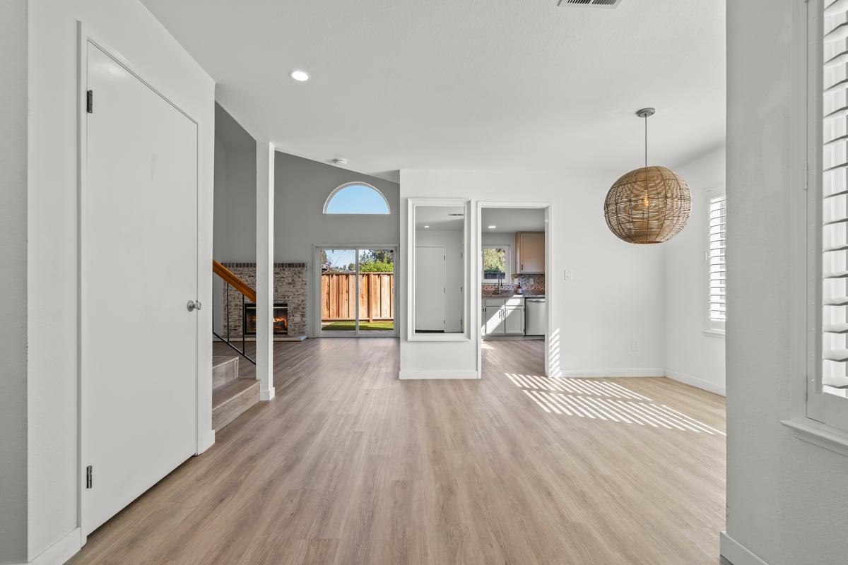 52 Winding Way Watsonville, CA 95076 - Photo 4 of 29 a view of an empty room with wooden floor and a window