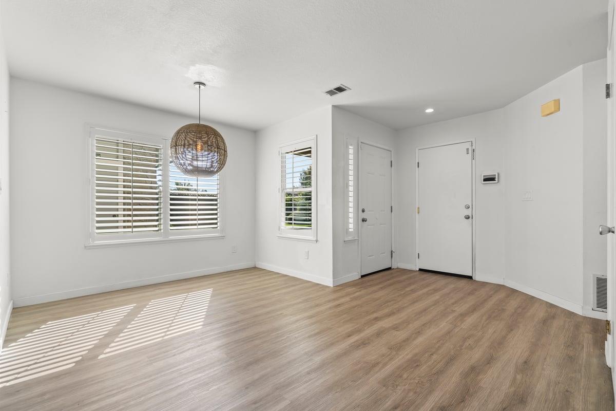 52 Winding Way Watsonville, CA 95076 - Photo 5 of 29 a view of an empty room with wooden floor and a window