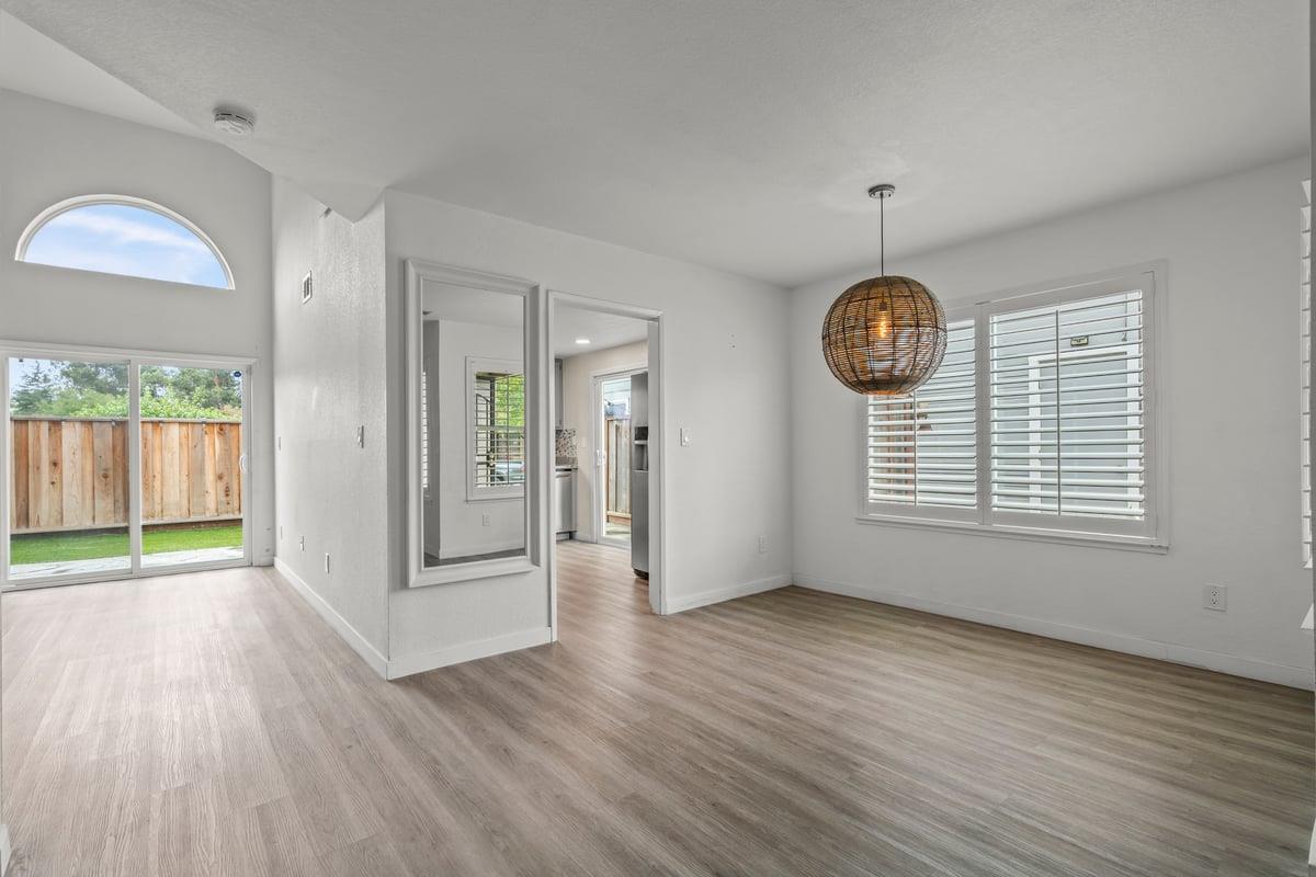 52 Winding Way Watsonville, CA 95076 - Photo 7 of 29 an empty room with wooden floor and windows