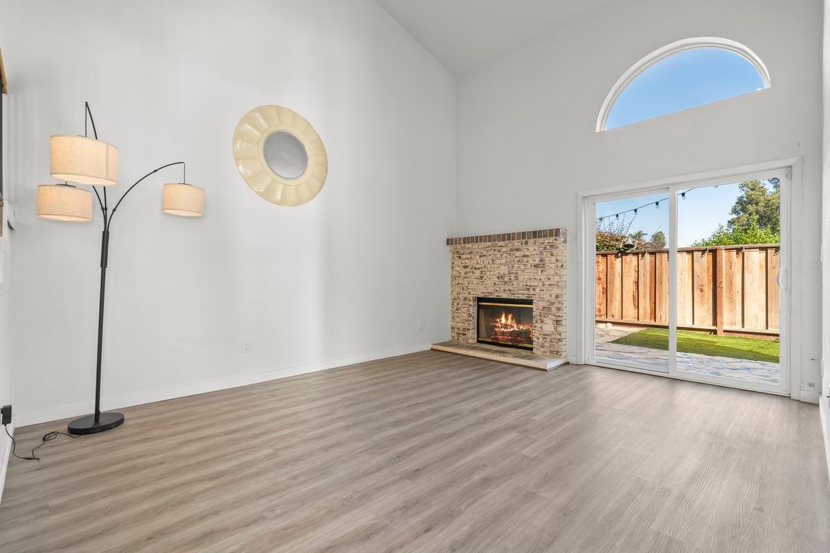 52 Winding Way Watsonville, CA 95076 - Photo 8 of 29 an empty room with windows fireplace and wooden floor