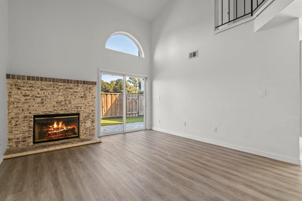 52 Winding Way Watsonville, CA 95076 - Photo 9 of 29 a view of an empty room with wooden floor fireplace and a window
