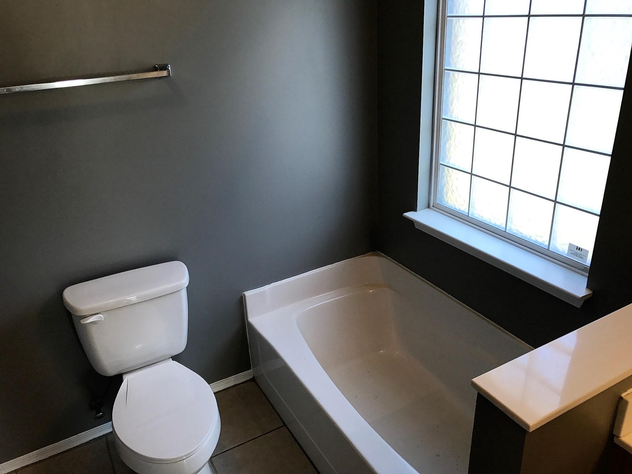 804 Travis Court Crestview, FL 32536 - Photo 13 of 22 a white toilet sitting next to a window