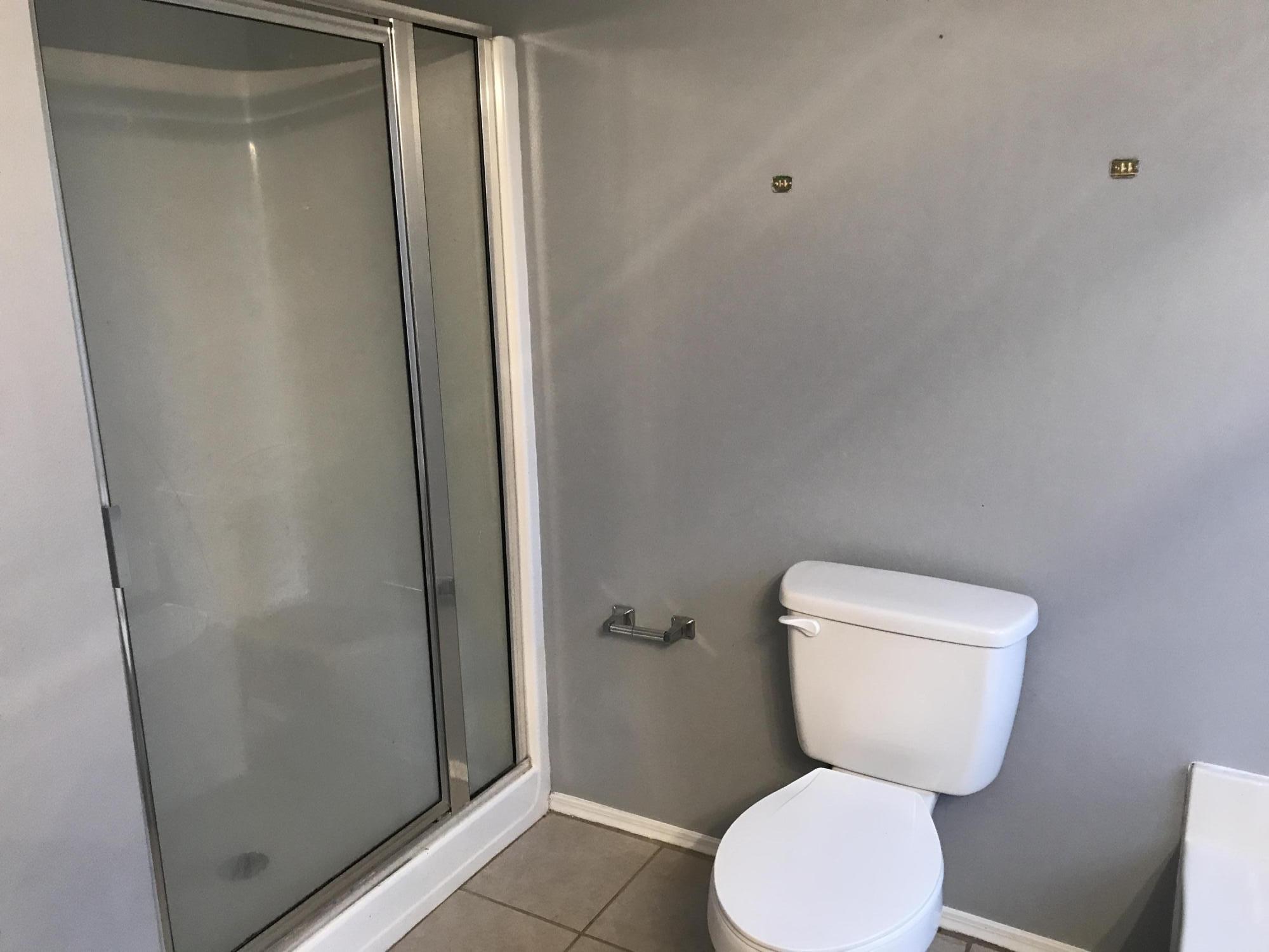 804 Travis Court Crestview, FL 32536 - Photo 14 of 22 a white toilet sitting next to a shower