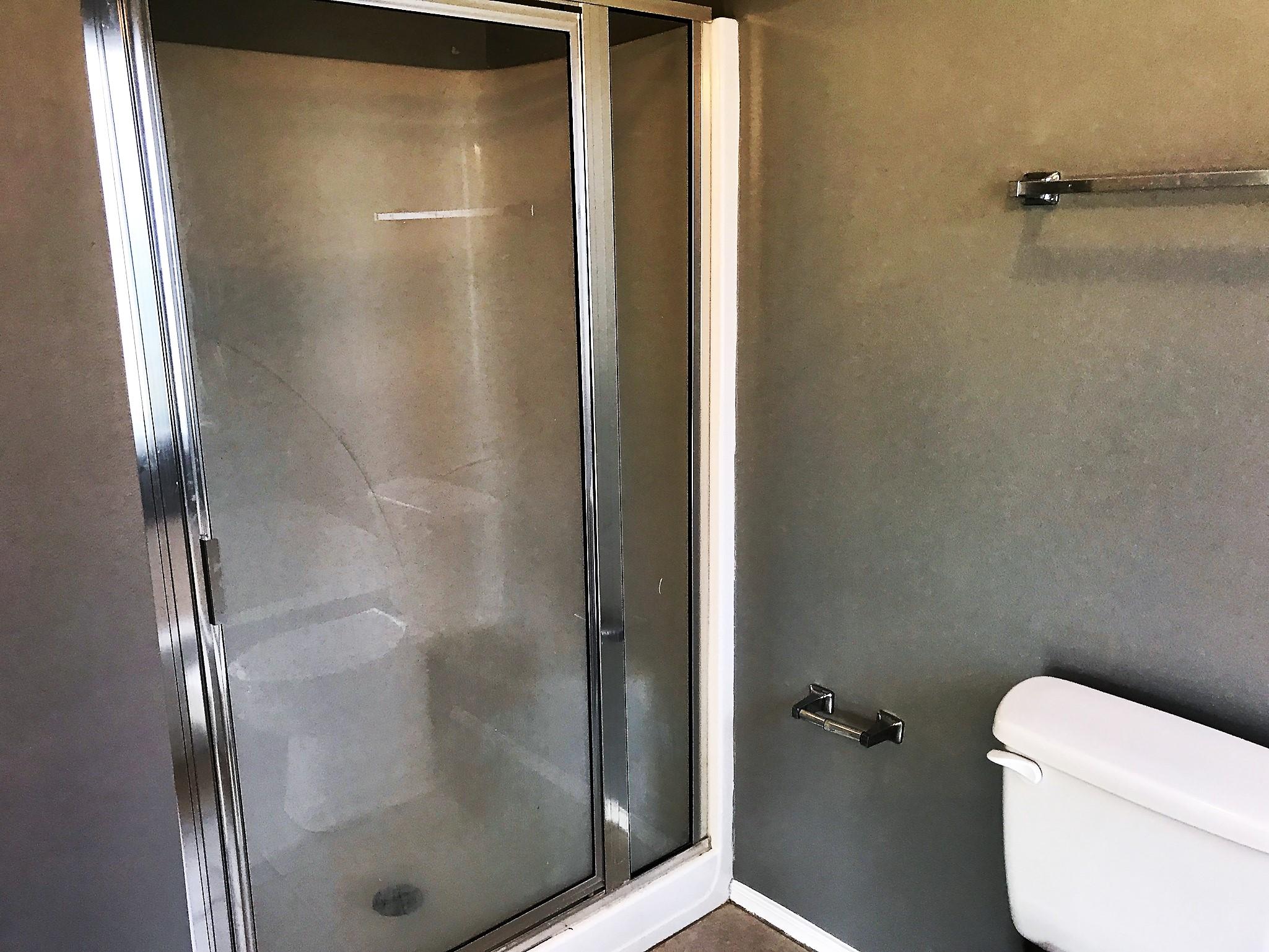 804 Travis Court Crestview, FL 32536 - Photo 15 of 22 a bathroom with a glass shower door