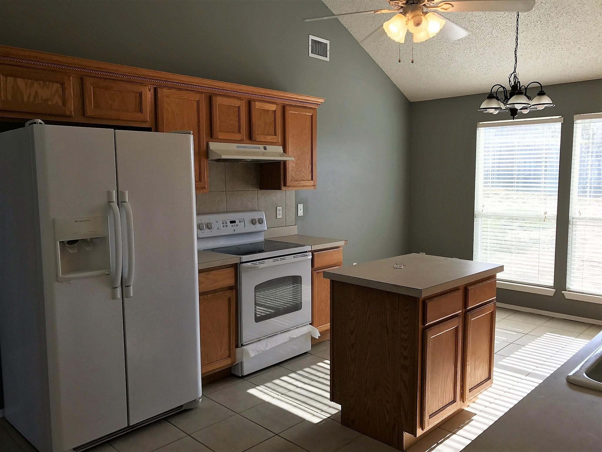 804 Travis Court Crestview, FL 32536 - Photo 7 of 22 a kitchen with a stove sink and refrigerator