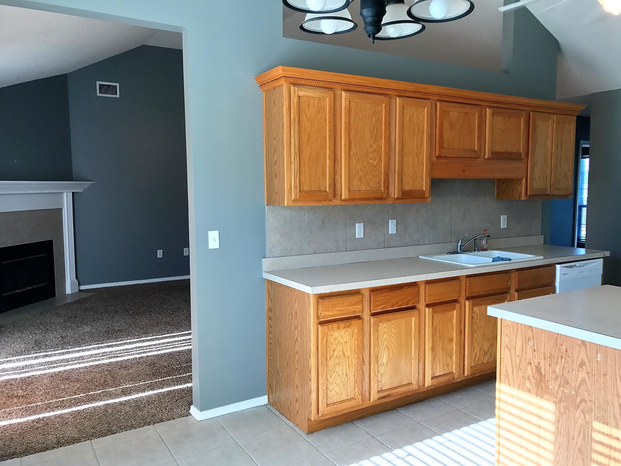 804 Travis Court Crestview, FL 32536 - Photo 8 of 22 a kitchen with stainless steel appliances granite countertop a stove a sink and a microwave