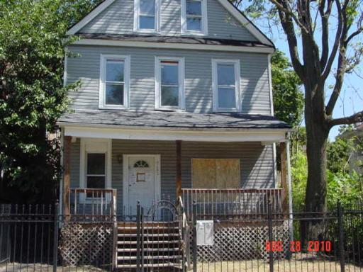 7151 South Normal Boulevard Chicago, IL 60621 - Photo 1 of 1 a front view of a house with glass windows and plants