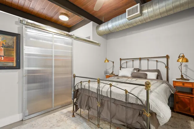 a bedroom with a bed and cabinets