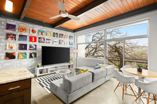 a living room with furniture and kitchen view