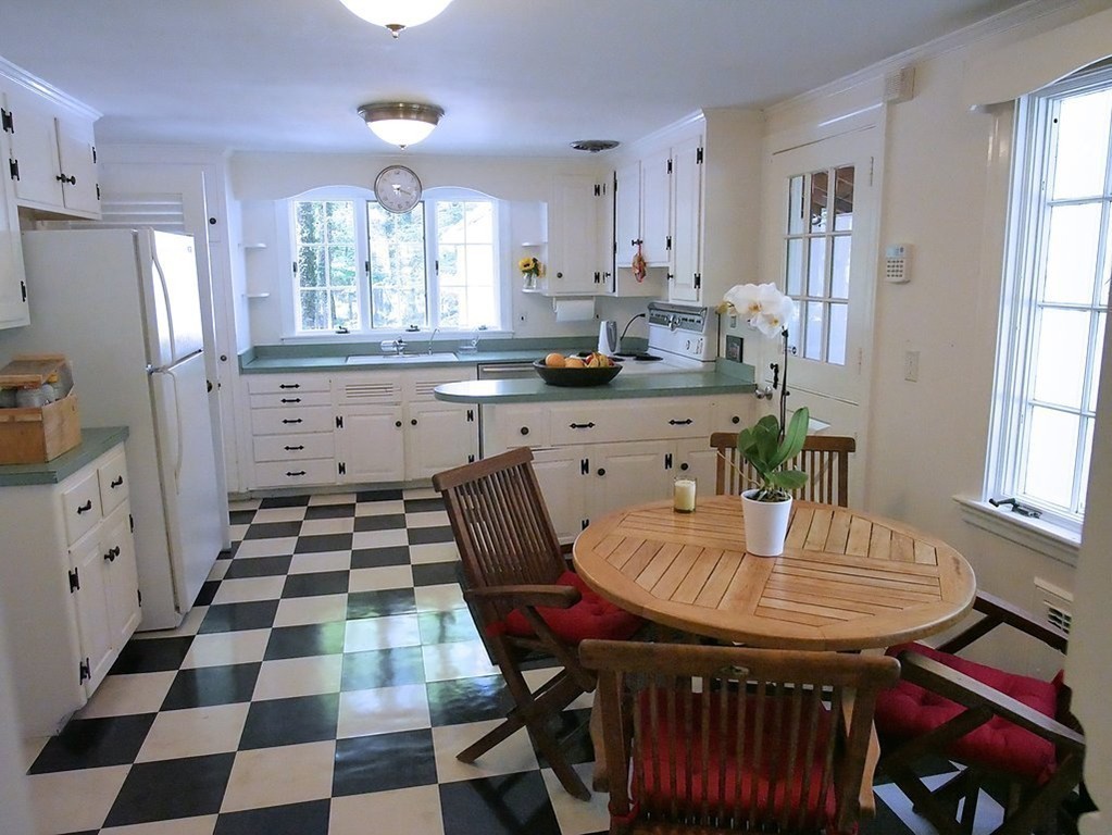 52 Montvale Road Weston, MA 02493 - Photo 13 of 30 a kitchen with stainless steel appliances granite countertop a stove a sink a refrigerator a dining table and chairs with wooden floor