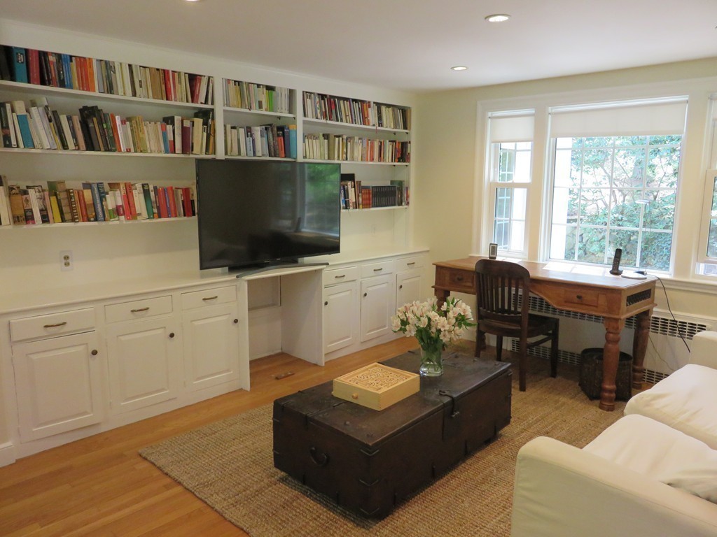 52 Montvale Road Weston, MA 02493 - Photo 15 of 30 a living room with furniture bookshelf and a flat screen tv