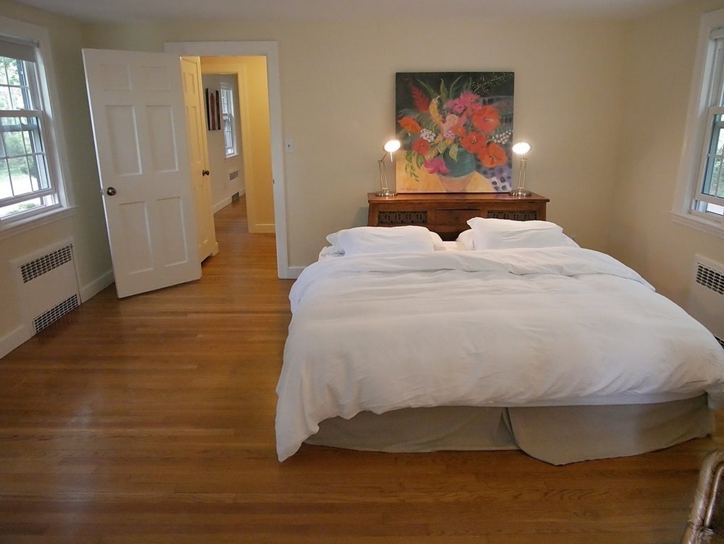 52 Montvale Road Weston, MA 02493 - Photo 17 of 30 a bed with wooden floor and window