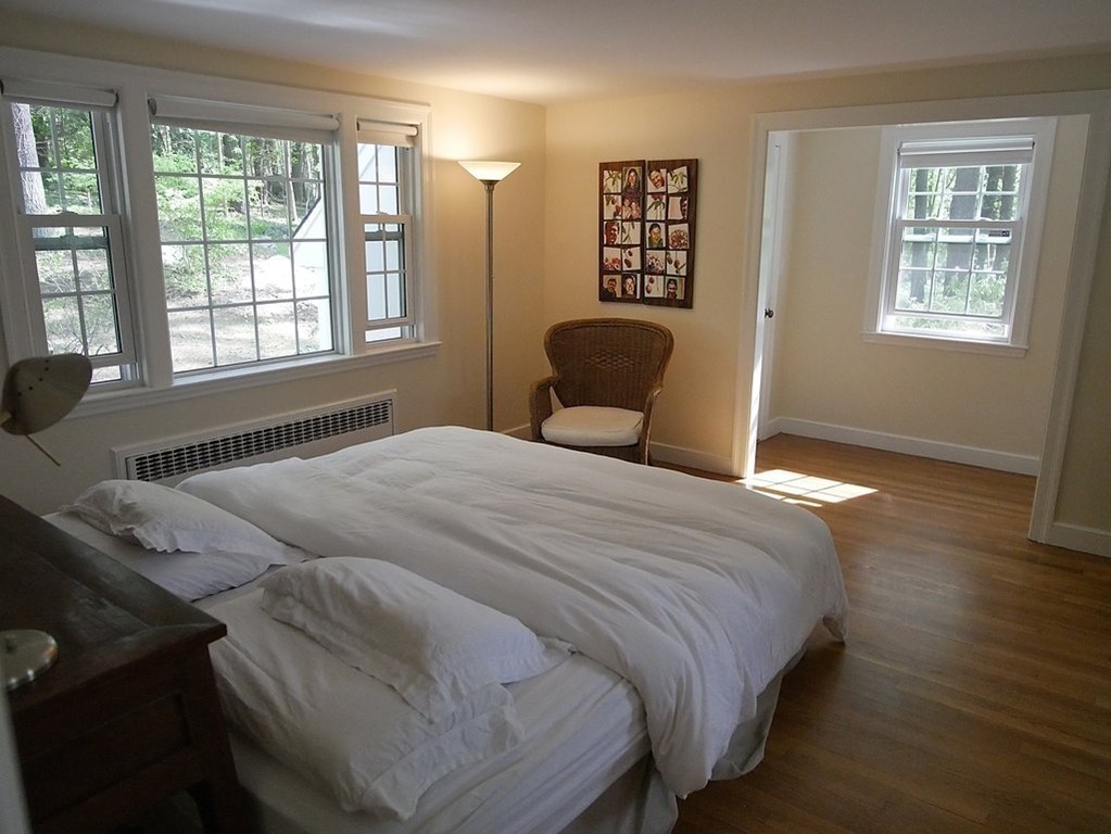 52 Montvale Road Weston, MA 02493 - Photo 18 of 30 a bedroom with a bed and wooden floor
