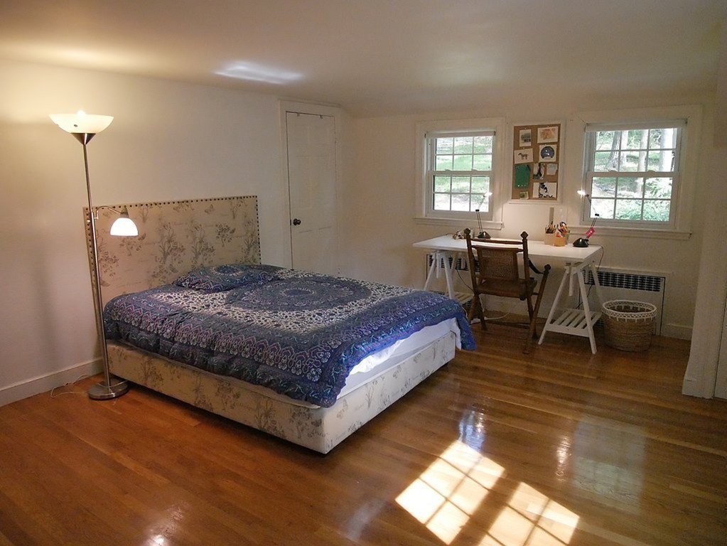 52 Montvale Road Weston, MA 02493 - Photo 19 of 30 a bedroom with a bed and a table in it