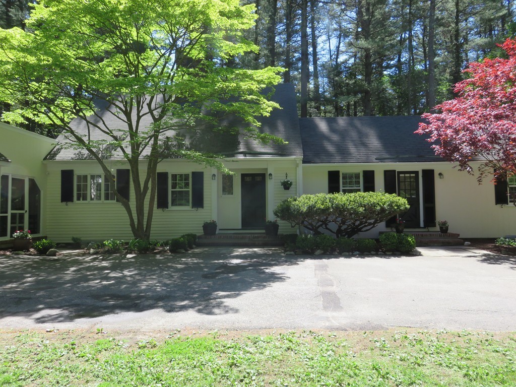 52 Montvale Road Weston, MA 02493 - Photo 3 of 30 a front view of a house with a yard and a garage