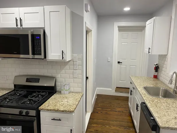 a kitchen with a stove and a sink